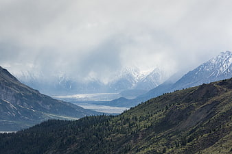 Misty Mountain Valley with Glacier and Forested Slopes
