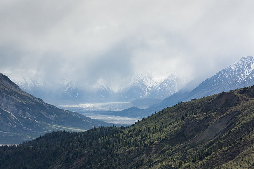 Misty Mountain Valley with Glacier and Forested Slopes