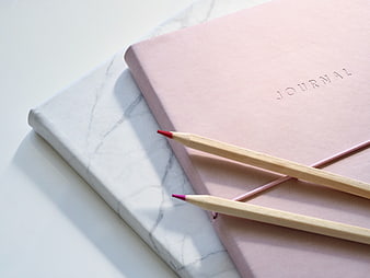 Minimalist Pink Journal and Pencils on Marble Surface