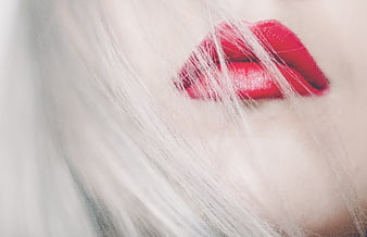 Close-up of red lips and white hair