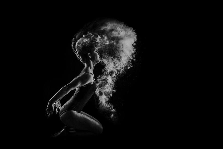 Woman dissolving into smoke in black and white