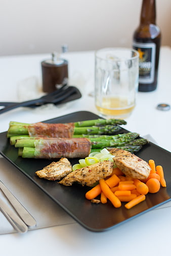 Grilled chicken and bacon-wrapped asparagus with beer