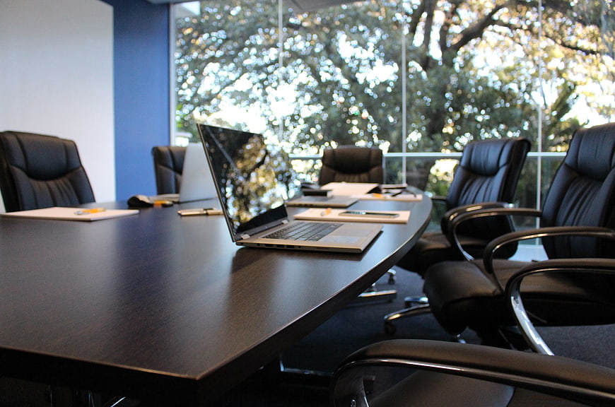 Modern boardroom with laptop and chairs ready for meeting