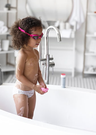 Cute Child in Bathtub with Pink Goggles and Soap