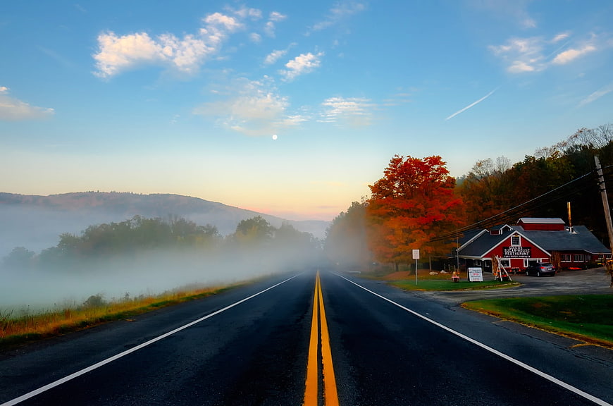 Scenic Autumn Highway With Fog And Red Barn In Massachusetts