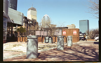 Urban Plaza With Concrete Bollards And City Skyline