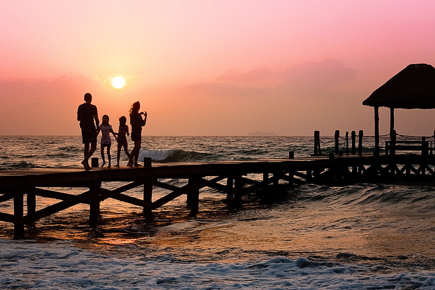 Family Silhouette on Wooden Pier at Sunset