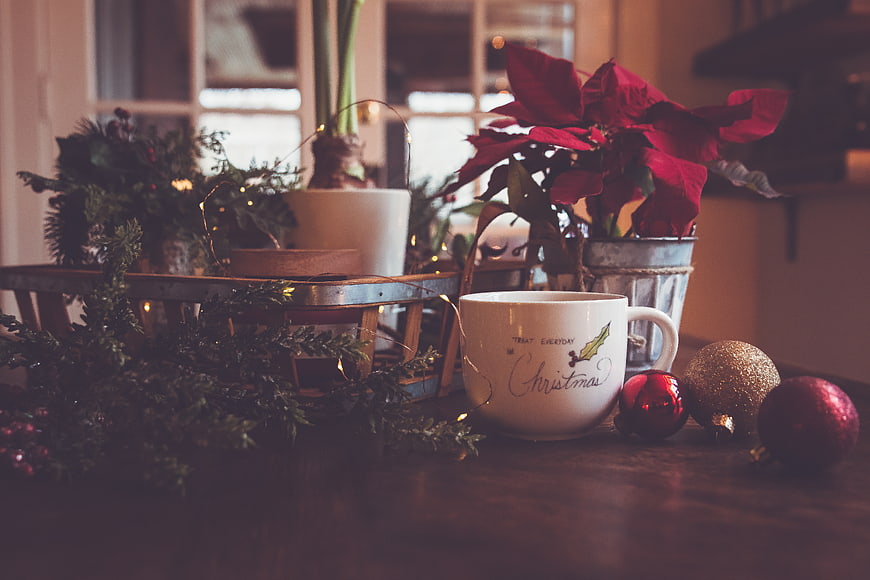 Cozy Christmas Table Setting with Mug and Poinsettia