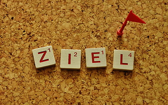 German word Ziel meaning goal spelled with wooden tiles and red flag