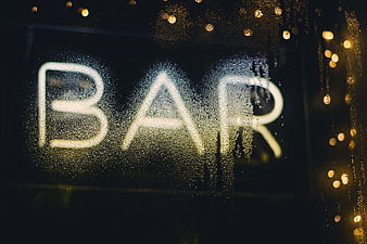 Neon Bar Sign Through Rainy Window at Night