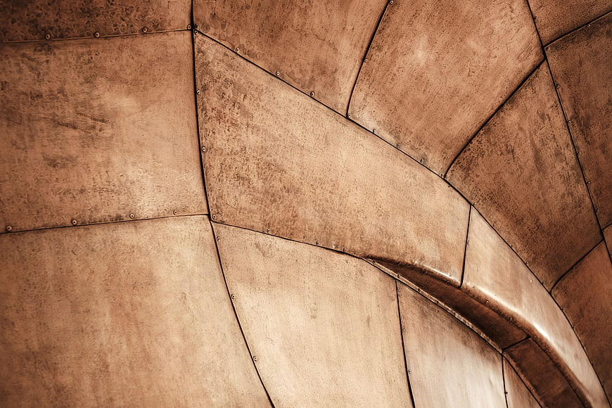 Abstract copper metal architectural texture with rivets