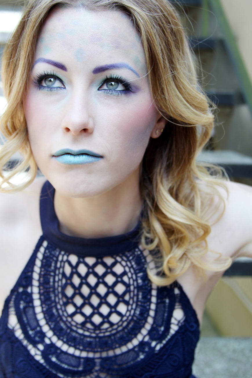Portrait of Woman with Blue and Purple Fantasy Makeup