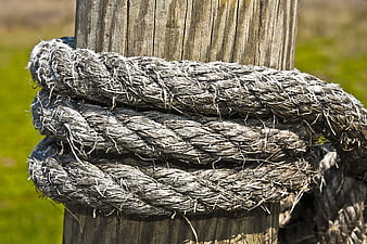 Weathered Rope Wrapped Around Wooden Post