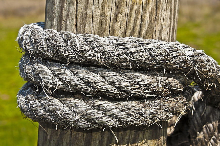 Weathered Rope Wrapped Around Wooden Post