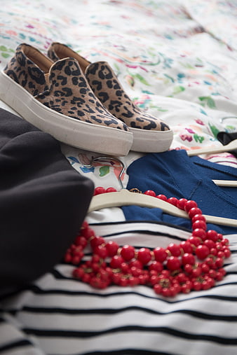 Leopard Print Sneakers and Red Beaded Necklace on Bed
