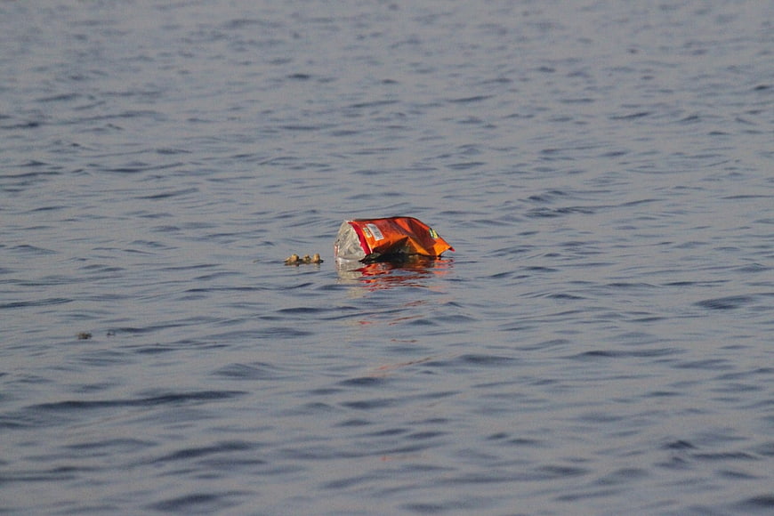 Plastic Bag Floating In Gray Water Pollution