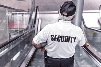 Security Guard on Escalator Back View