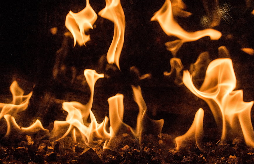 Close-up of flickering orange flames on dark background