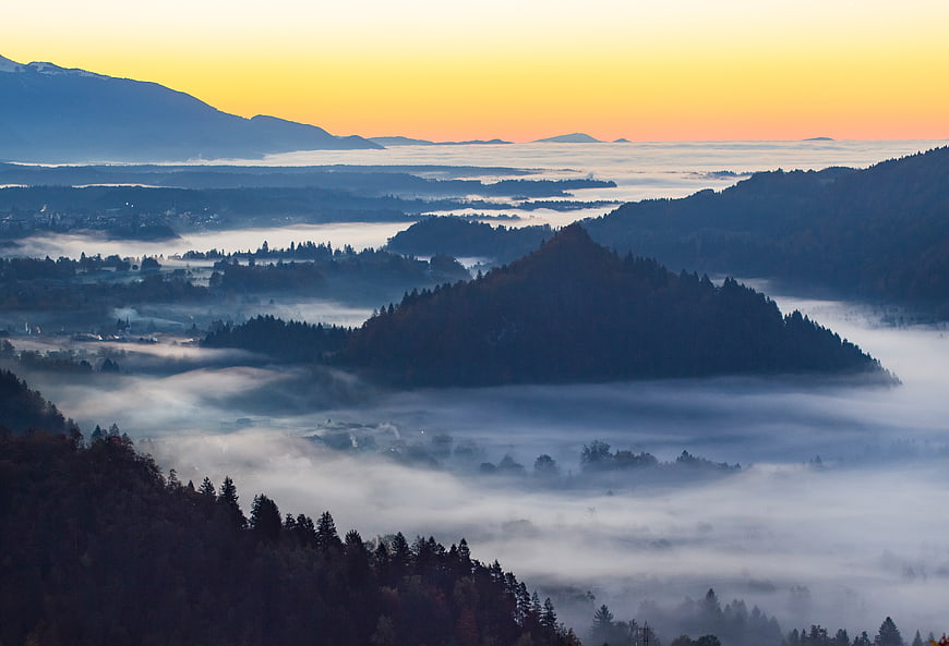 Misty Mountain Valley at Sunrise with Golden Sky