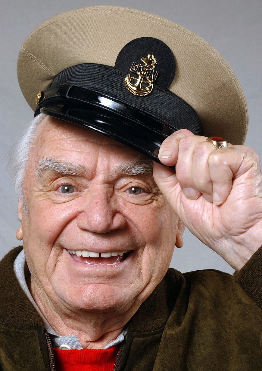 Portrait of smiling elderly man in captain hat
