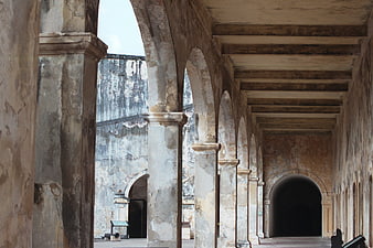 Historic stone arches and columns in an old fort corridor