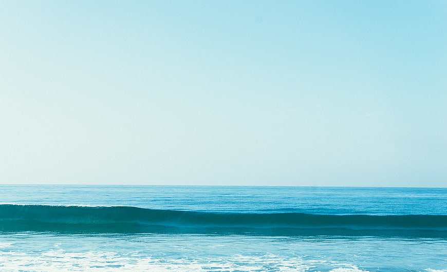 Minimalist Blue Ocean Wave with Large Sky Copyspace