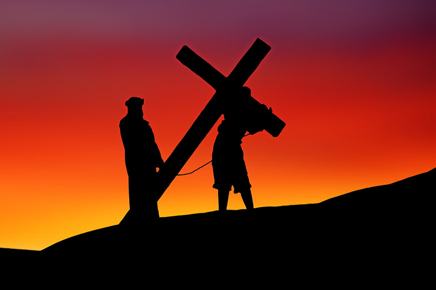 Silhouette of Jesus Carrying Cross at Sunset