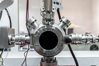 Close-up of stainless steel vacuum chamber with flanges