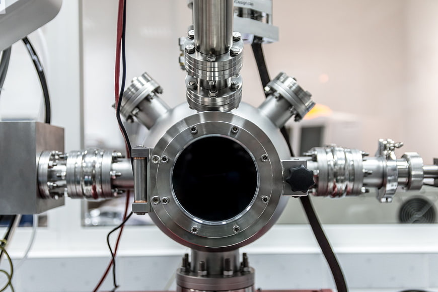 Close-up of stainless steel vacuum chamber with flanges