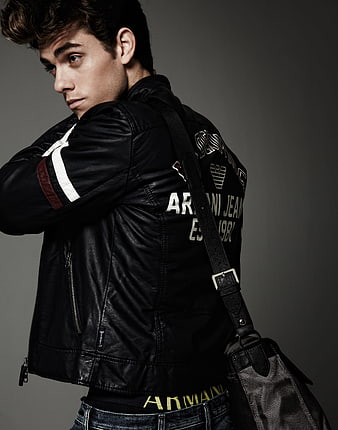 Young man in black leather jacket with shoulder bag