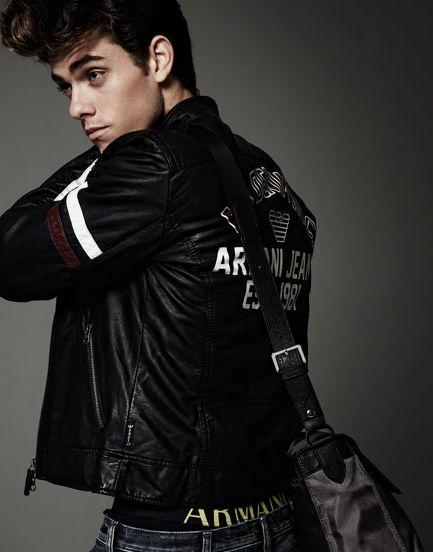 Young man in black leather jacket with shoulder bag