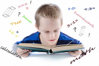 Young boy reading book with floating math equations and school words
