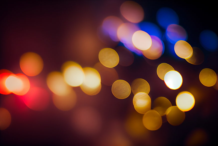 Abstract colorful bokeh lights background with blurred festive glow