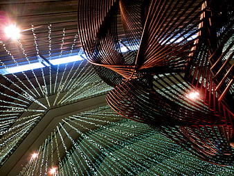 Abstract copper sculpture with radiating light strings