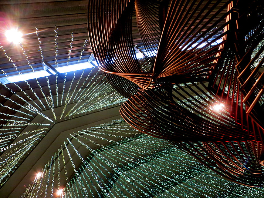 Abstract copper sculpture with radiating light strings