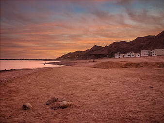 Sunset Landscape of Dahab Beach with Mountains and Buildings
