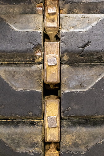 Close-up of worn industrial bulldozer tracks and metal treads