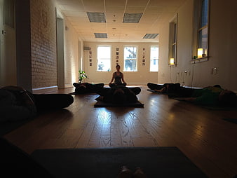 Yoga class meditation session in studio with instructor