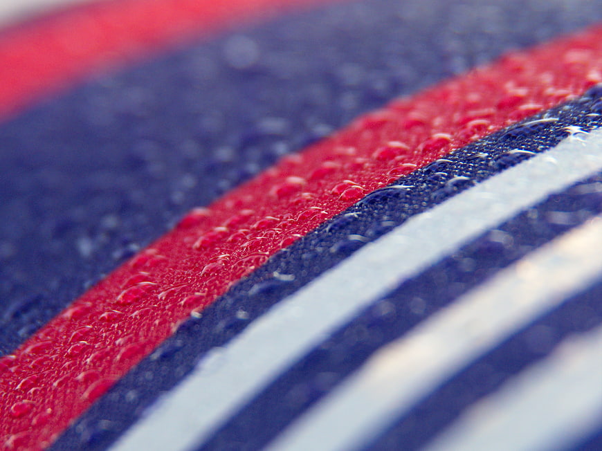 Macro Water Droplets on Red and Blue Striped Fabric