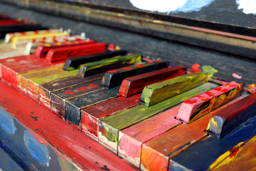 Close-up of colorful painted piano keys with artistic texture