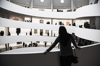 Woman looking down at spiral museum architecture