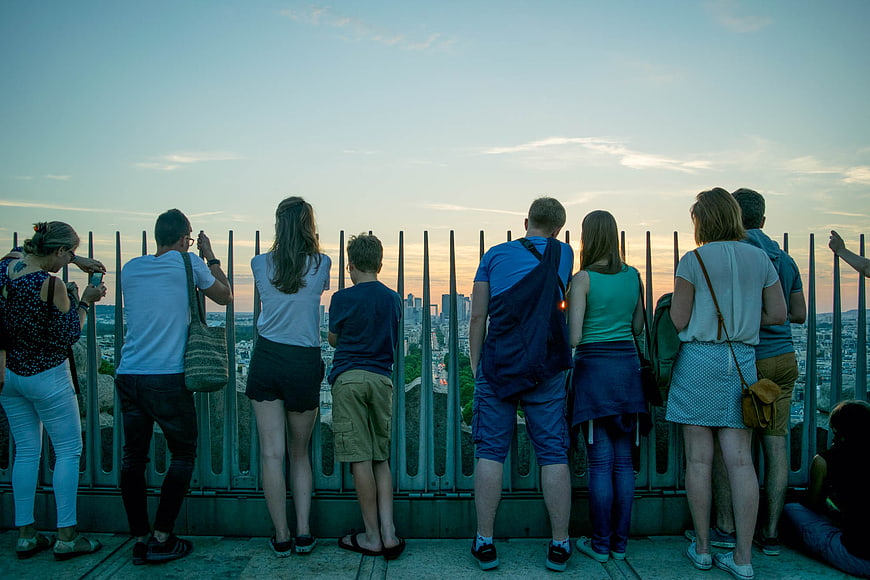 Group of Tourists Viewing City Skyline at Sunset