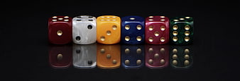Row of colorful dice on black reflective surface
