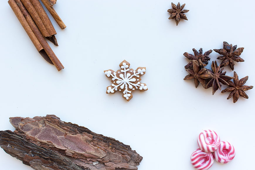 Christmas gingerbread snowflake with cinnamon and spices on white