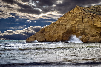 Dramatic Coastal Cliff Landscape With Stormy Sky And Crashing Waves