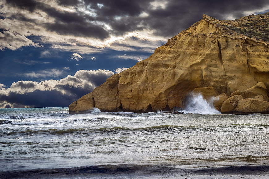 Dramatic Coastal Cliff Landscape With Stormy Sky And Crashing Waves
