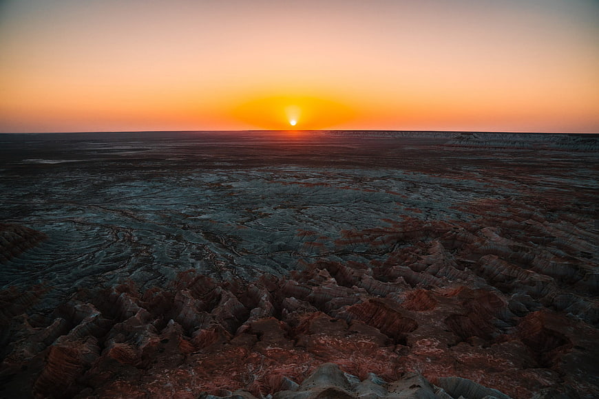 Dramatic Sunrise Over Eroded Desert Badlands Landscape