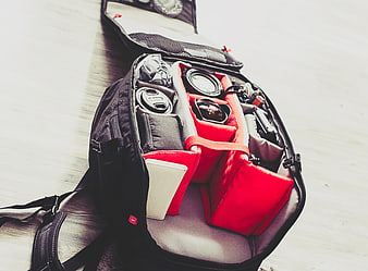 Open Camera Backpack with Red Dividers and Lenses