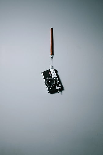 Vintage Canon Film Camera Hanging on Gray Wall