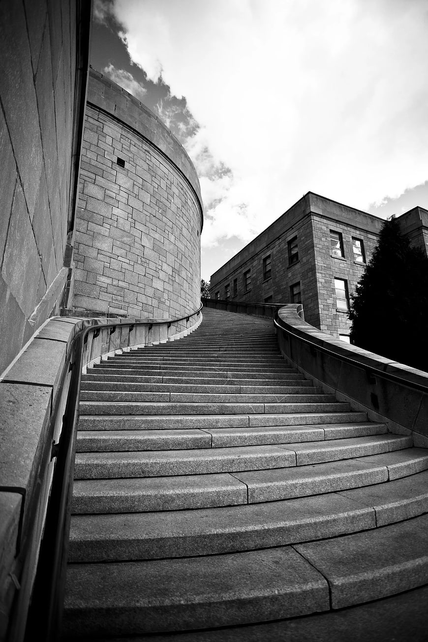 Black and White Photo of Curved Concrete Staircase